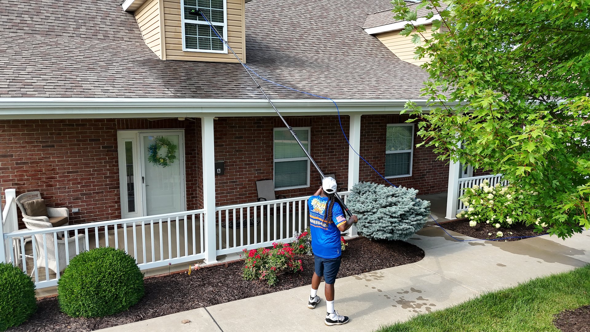 Image of General Suds Pressure Washing performing an exterior window cleaning.